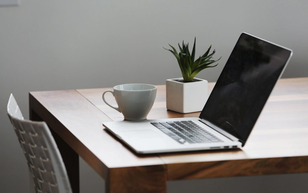 Photo of laptop and coffee cup on wood desk